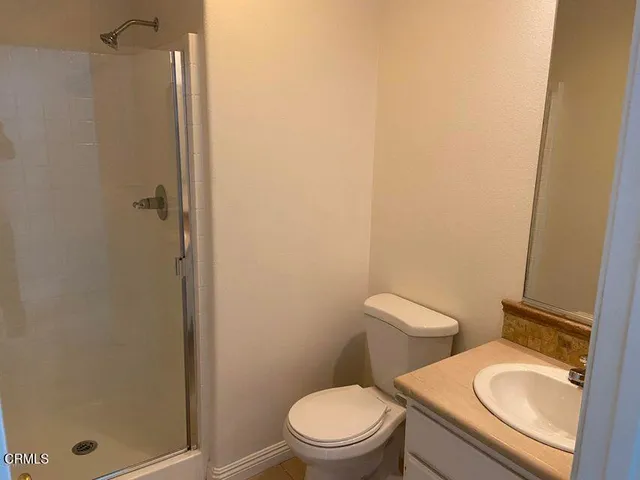a white toilet sitting next to a bathroom sink
