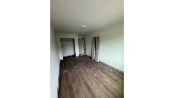 a view of a hallway with wooden floor