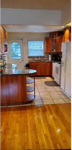 a kitchen with stainless steel appliances wooden cabinets a stove top oven a sink and dishwasher