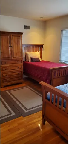 a bedroom with a bed and a dresser
