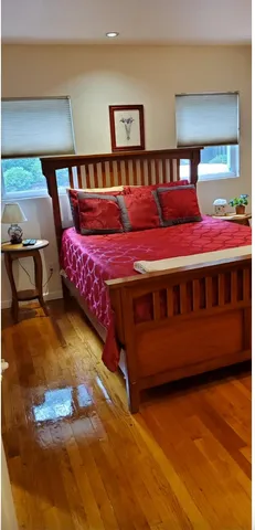 a bedroom with a bed and two night stand