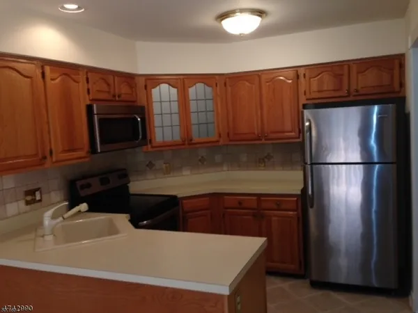 a kitchen with a refrigerator and a microwave