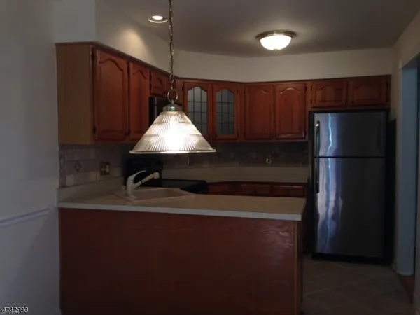 a kitchen with a refrigerator and a sink
