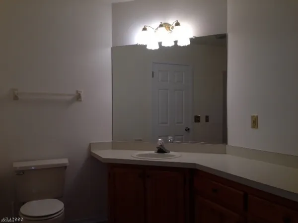 a bathroom with a sink toilet and a mirror