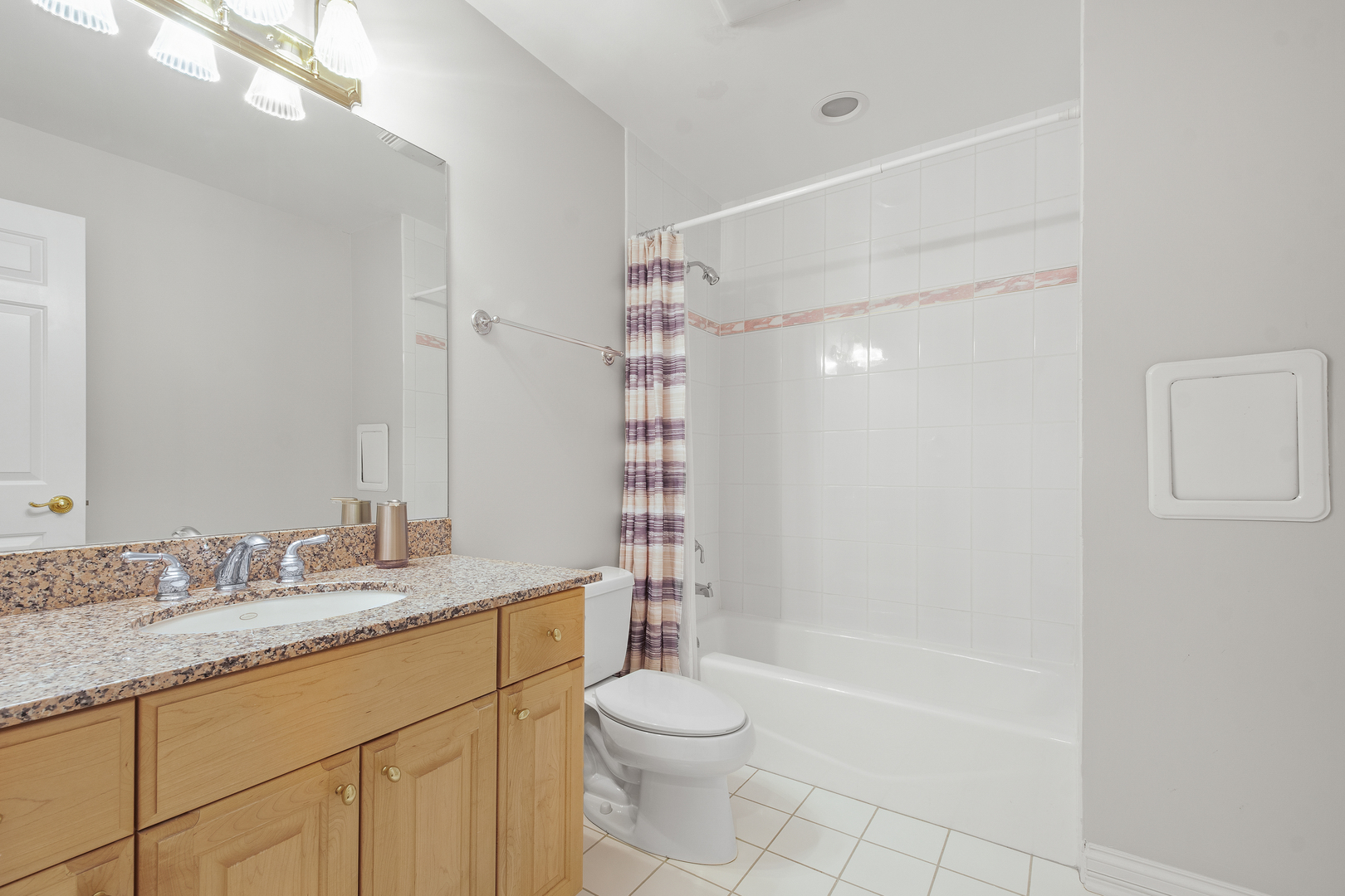 1830 Telegraph Road Lake Forest, IL 60045 - Photo 19 of 33 a bathroom with a granite countertop sink a toilet a mirror and shower