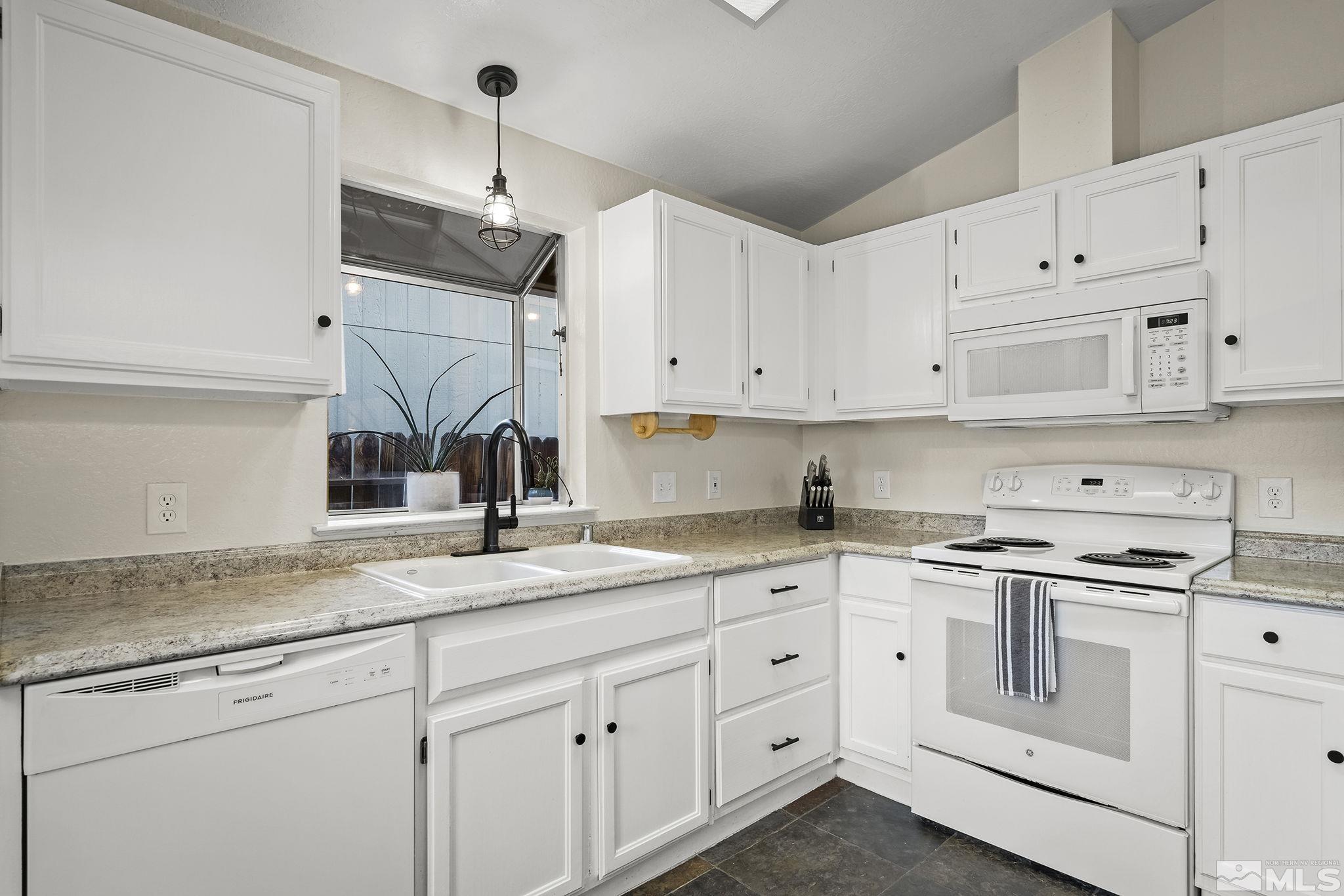 6036 Warm River Road Reno, NV 89523 - Photo 15 of 29 a kitchen with cabinets appliances a sink and a counter top