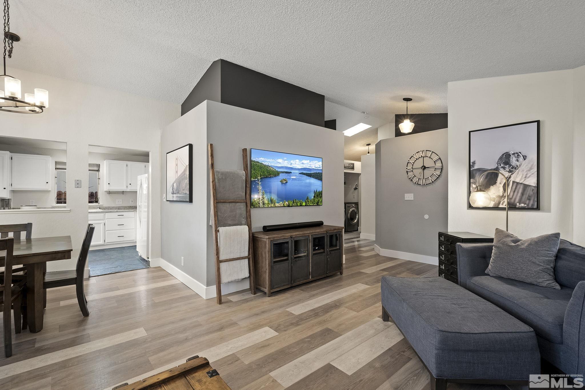 6036 Warm River Road Reno, NV 89523 - Photo 8 of 29 a living room with furniture and a flat screen tv