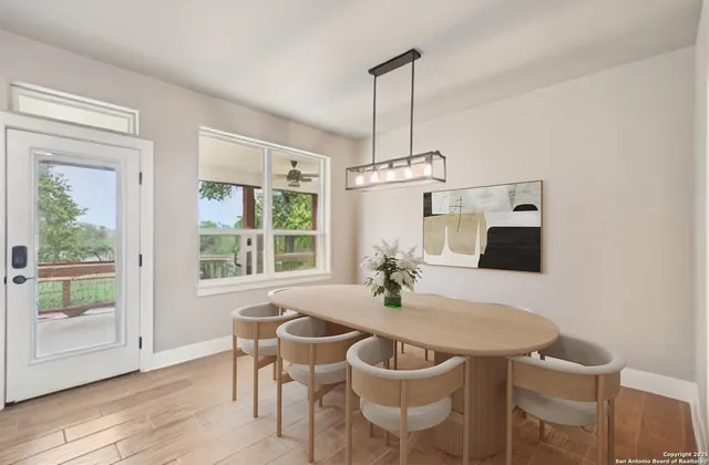 a view of a dining room with furniture window and wooden floor