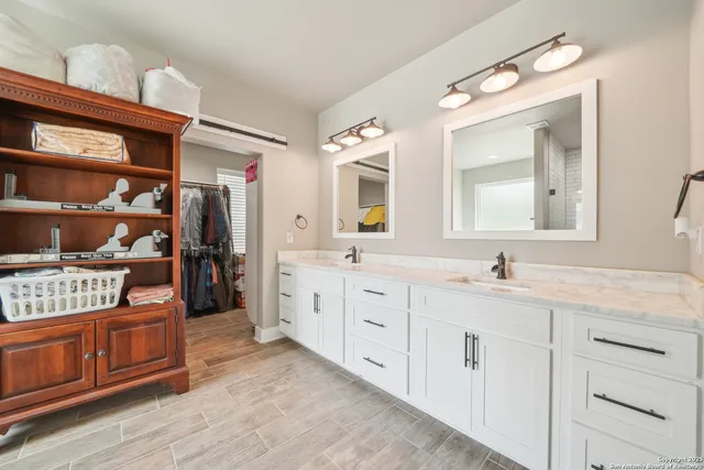 a bathroom with a tub sink shower and mirror
