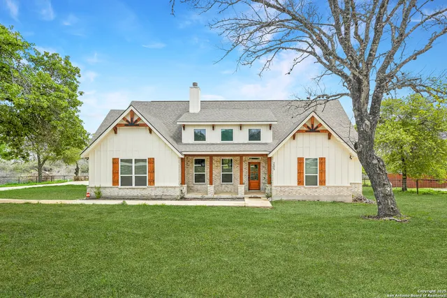 a front view of house with yard and green space