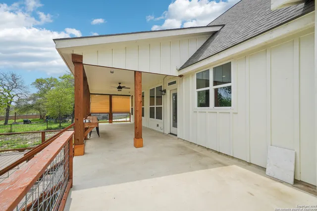 a view of a house with a yard and sitting area