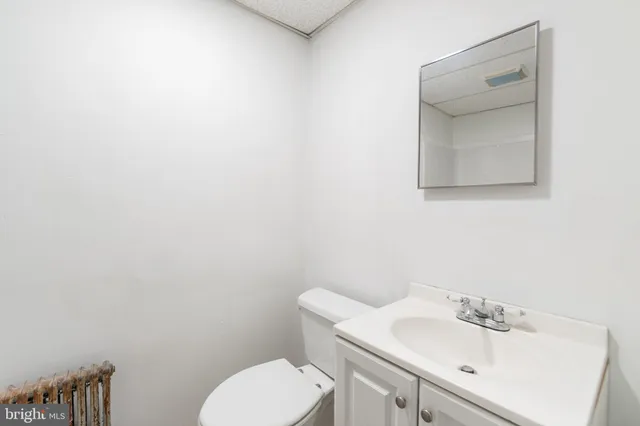 a bathroom with a sink a toilet and mirror