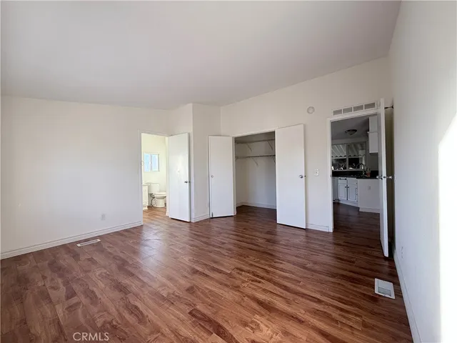 a view of an empty room and wooden floor