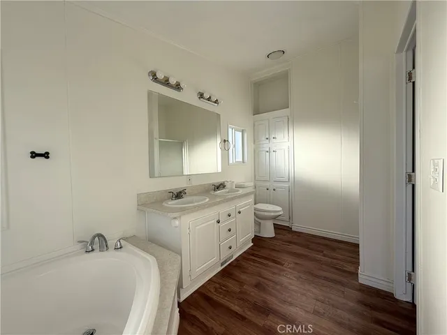 a bathroom with a double vanity sink and a mirror