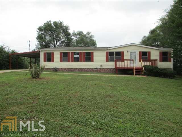 5733 Parks Road Cumming, GA 30041 - Photo 1 of 1 a front view of a house with garden