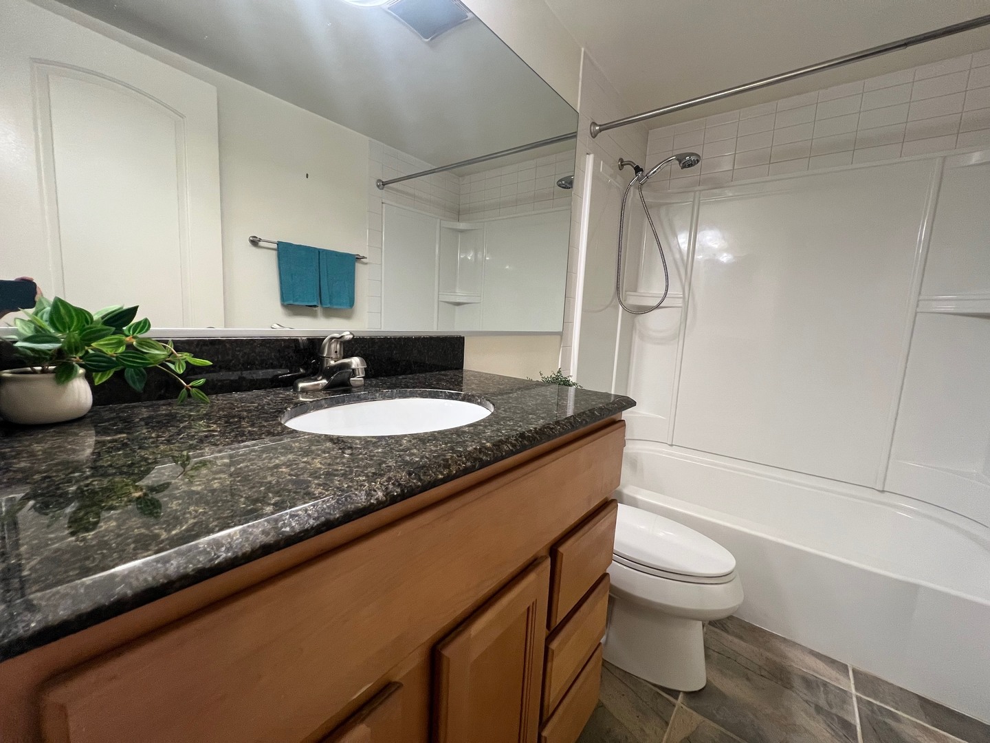 2219 Nichols Road, Unit 17A Arlington Heights, IL 60004 - Photo 7 of 19 a bathroom with a granite countertop sink a toilet a mirror and shower