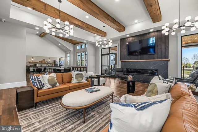 a living room with furniture a chandelier and a flat screen tv