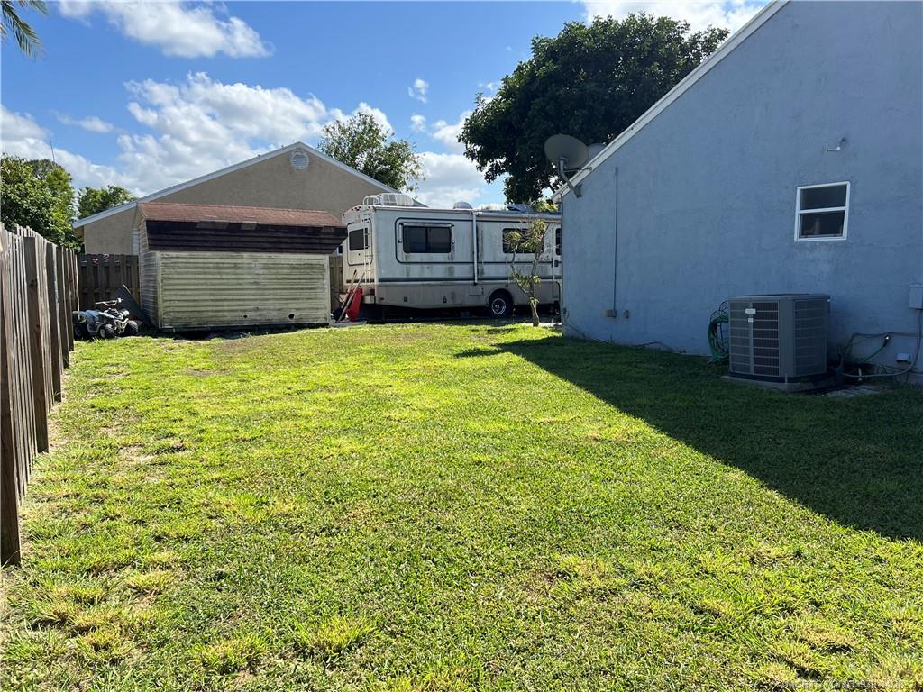 5140 Southeast Dell Street Stuart, FL 34997 - Photo 8 of 21 a view of a house with backyard and a tree