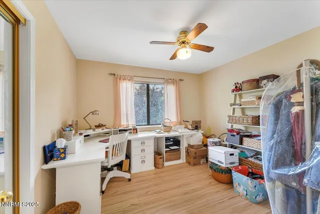 a view of a workspace with furniture and a window