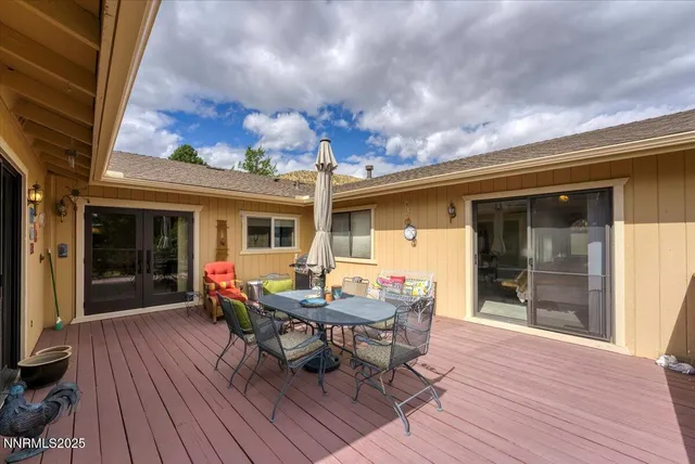 a view of a house with backyard sitting area and wooden floor