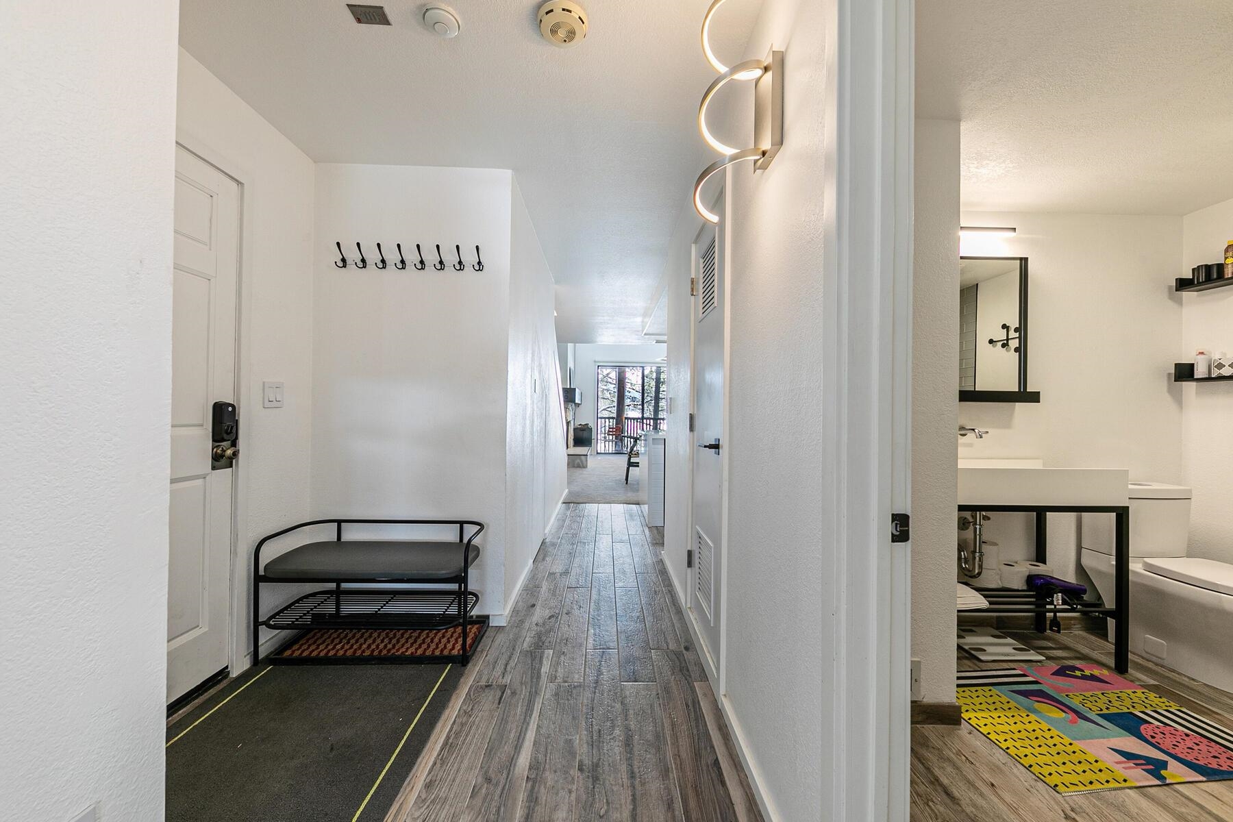 135 Alpine Meadows Road, Unit 15 Alpine Meadows, CA 96145 - Photo 5 of 28 a view of a hallway with workspace and wooden floor