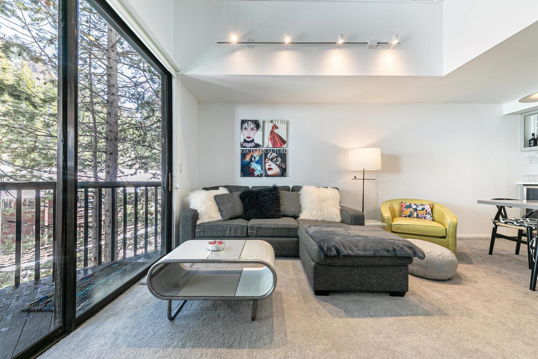 135 Alpine Meadows Road, Unit 15 Alpine Meadows, CA 96145 - Photo 9 of 28 a living room with furniture and a large window