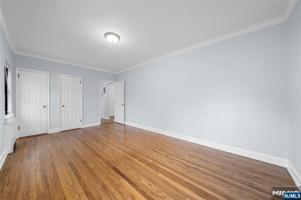 90 Tracey Place, Unit I1 Englewood, NJ 07631 - Photo 11 of 21 a view of an empty room with wooden floor