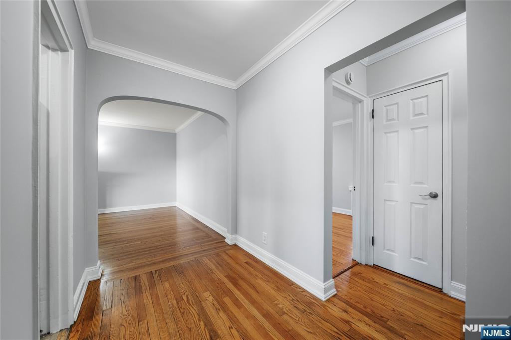 90 Tracey Place, Unit I1 Englewood, NJ 07631 - Photo 3 of 21 a view of hallway with wooden floor