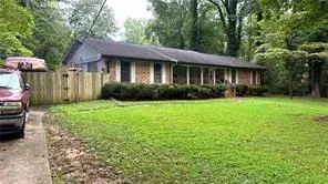 a view of a house with garden and yard