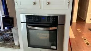 a stove top oven sitting inside of a kitchen