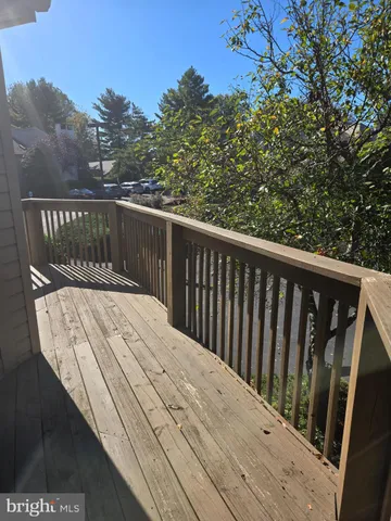 a view of balcony with wooden floor and fence