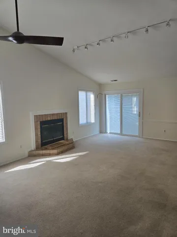 a view of empty room with a fireplace