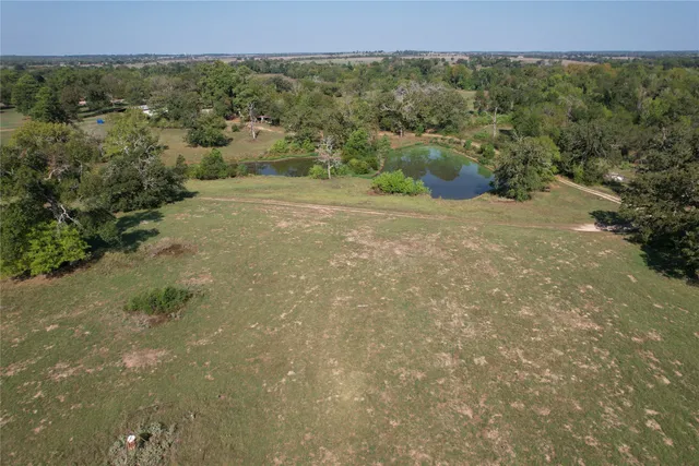 a view of a green field with lots of trees