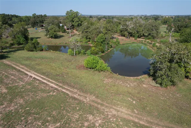 an aerial view of a houses with a yard
