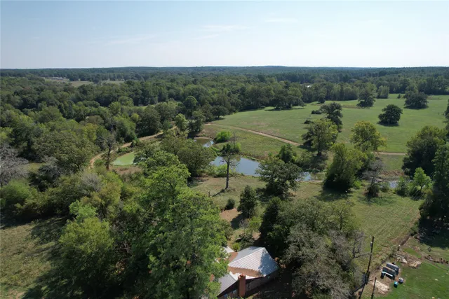 a view of a backyard with table and chairs under an umbrella