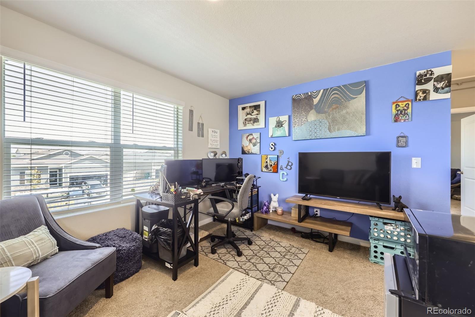 1063 Gianna Avenue Fort Lupton, CO 80621 - Photo 16 of 20 a living room with furniture and a flat screen tv