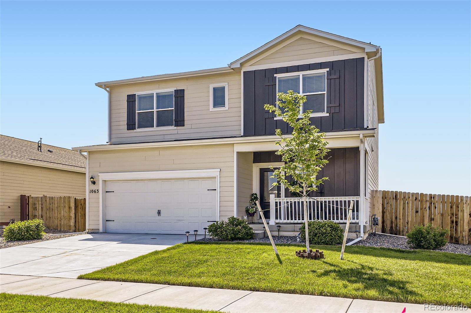 1063 Gianna Avenue Fort Lupton, CO 80621 - Photo 2 of 20 a front view of a house with a yard