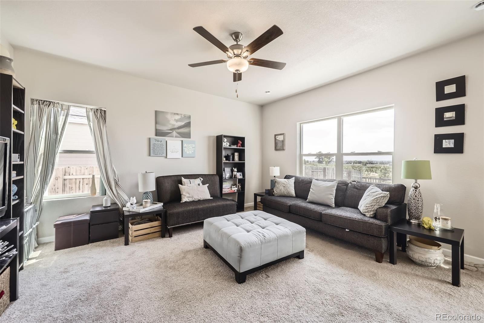 1063 Gianna Avenue Fort Lupton, CO 80621 - Photo 4 of 20 a living room with furniture and a large window