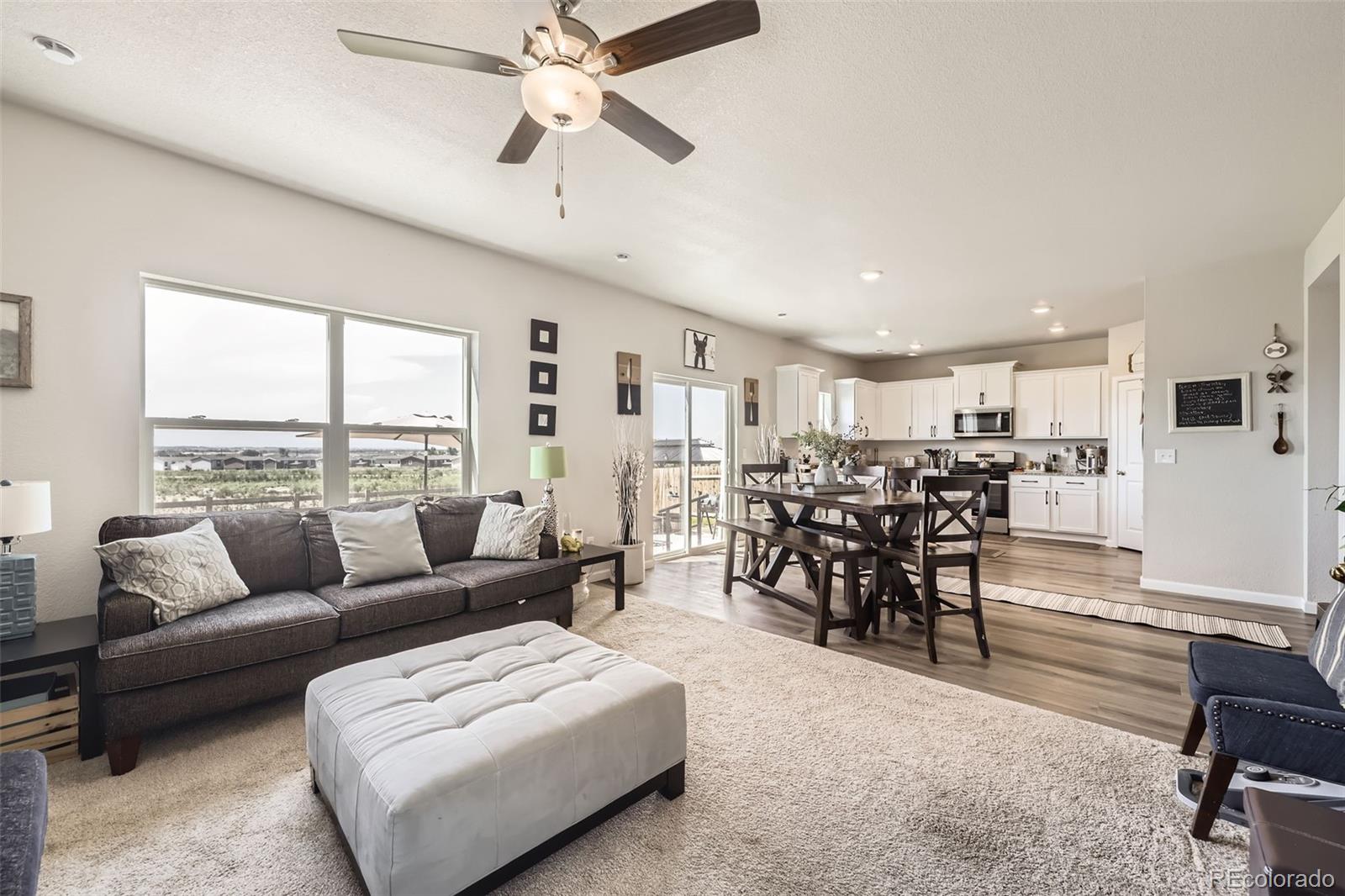 1063 Gianna Avenue Fort Lupton, CO 80621 - Photo 5 of 20 a living room with furniture and a large window