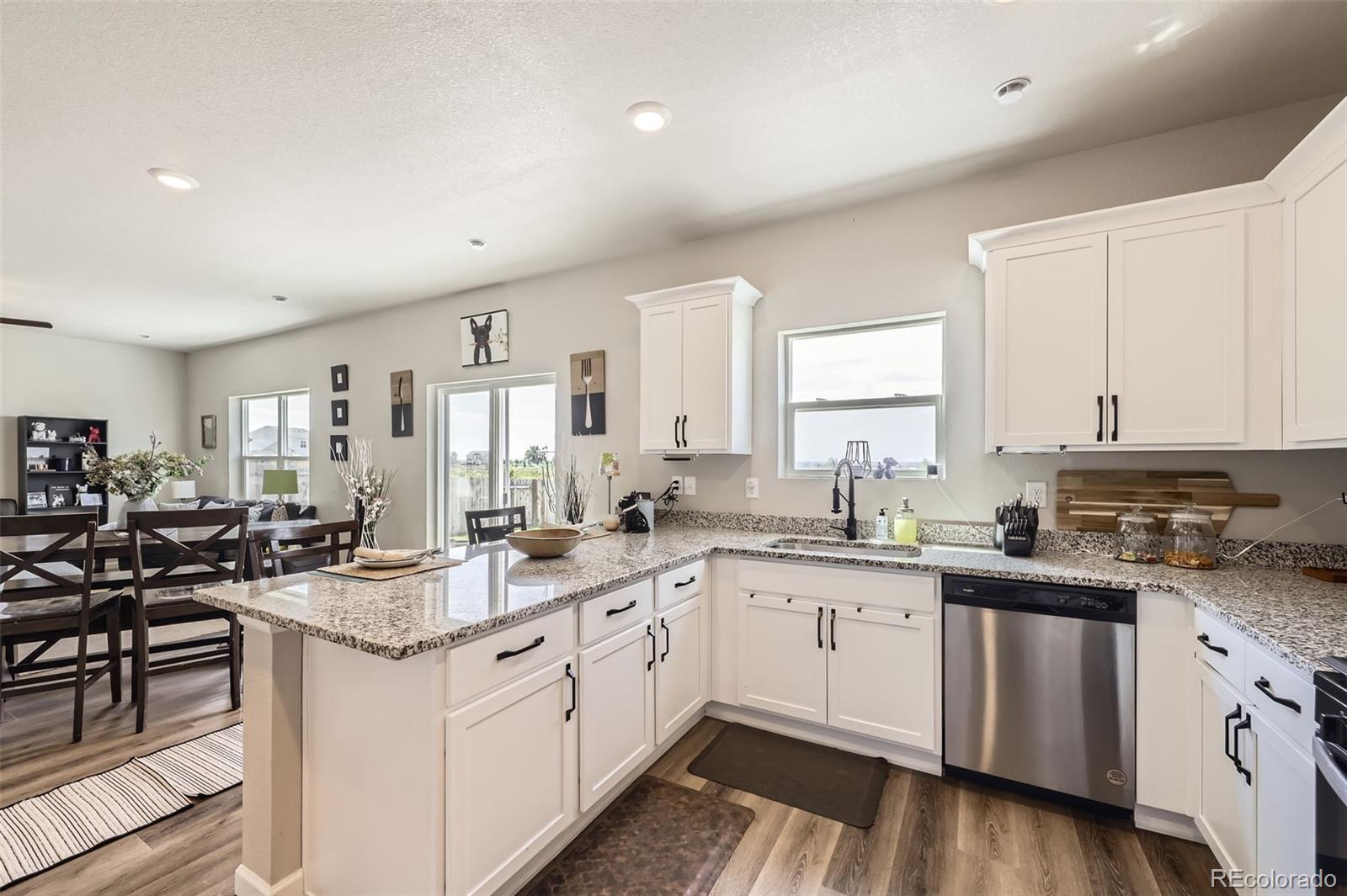 1063 Gianna Avenue Fort Lupton, CO 80621 - Photo 8 of 20 a kitchen with a sink stove and cabinets