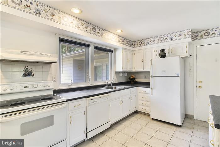 3227 Roderick Road Frederick, MD 21704 - Photo 9 of 23 a kitchen with granite countertop white cabinets and white appliances