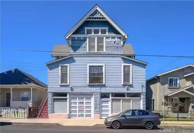 a front view of a residential apartment building with a street