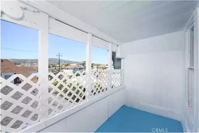 a view of an empty room and a window