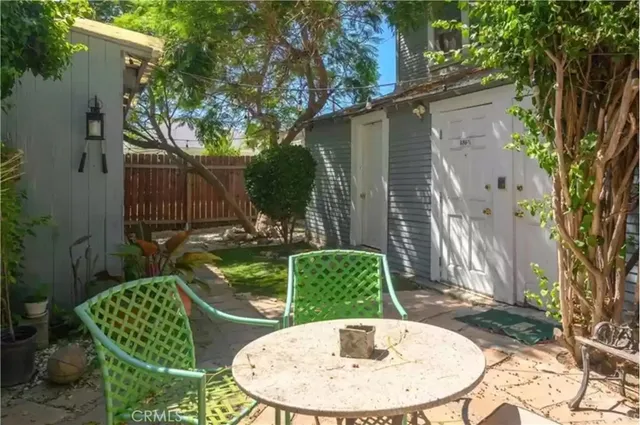 a backyard of a house with barbeque oven