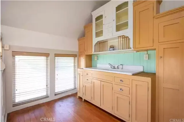 a bathroom with a granite countertop sink and a window