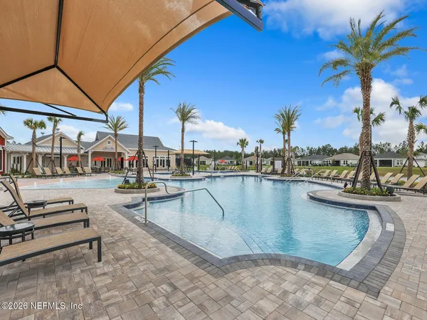 a view of a swimming pool with chairs