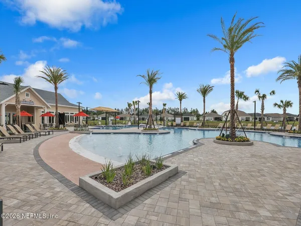 a swimming pool with outdoor seating and yard