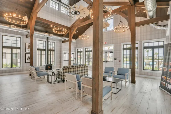 a lobby with furniture and floor to ceiling windows