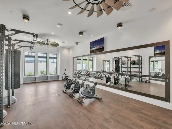 a living room with furniture large window and flat screen tv
