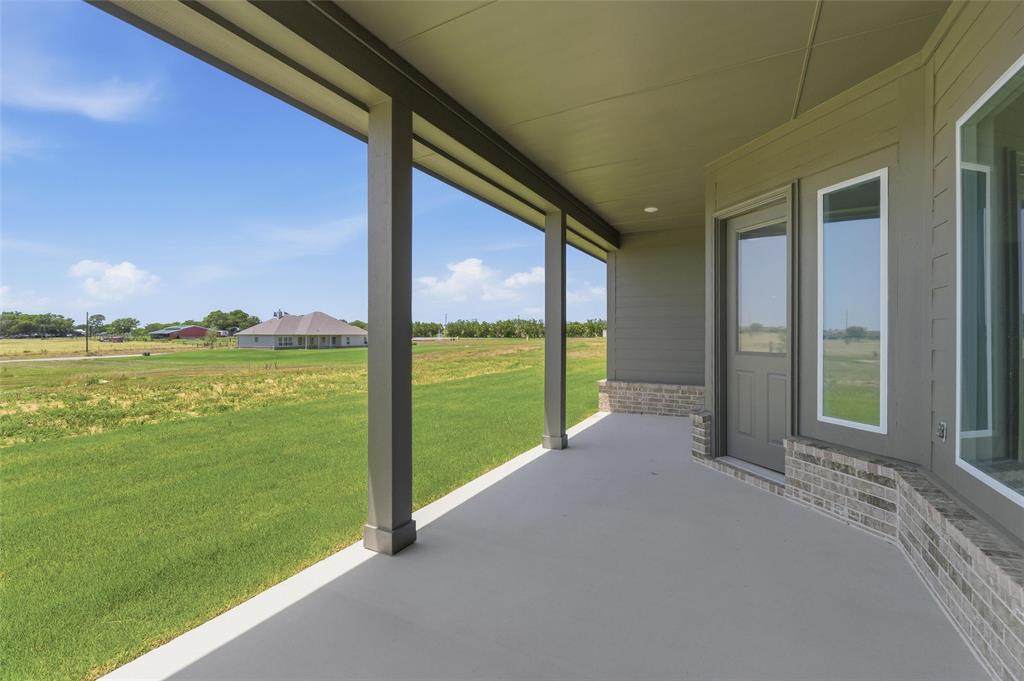 114 Hillview Trail Decatur, TX 76234 - Photo 23 of 27 Covered patio featuring a concrete surface, gray siding, and a partial brick facade
